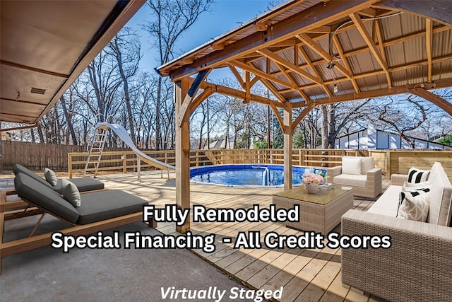 view of pool featuring a gazebo, outdoor lounge area, and a water slide