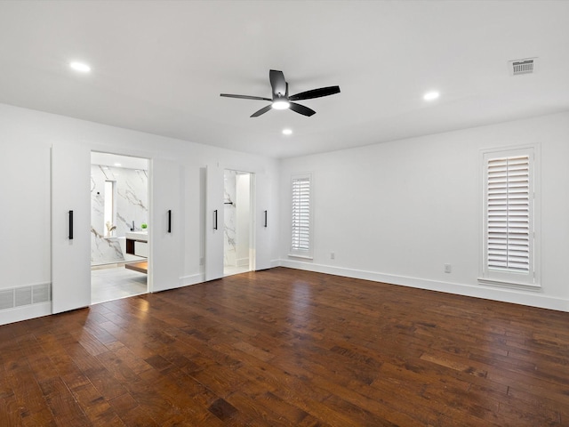 unfurnished room with dark hardwood / wood-style flooring and ceiling fan