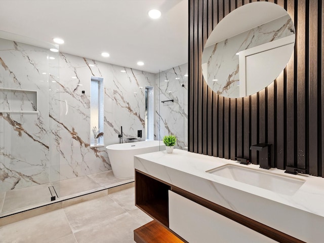 bathroom featuring vanity, plus walk in shower, and tile walls