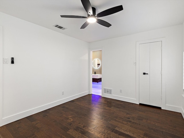 unfurnished bedroom featuring dark hardwood / wood-style floors and ceiling fan