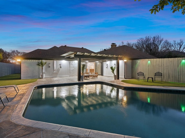 pool at dusk featuring a pergola and a patio