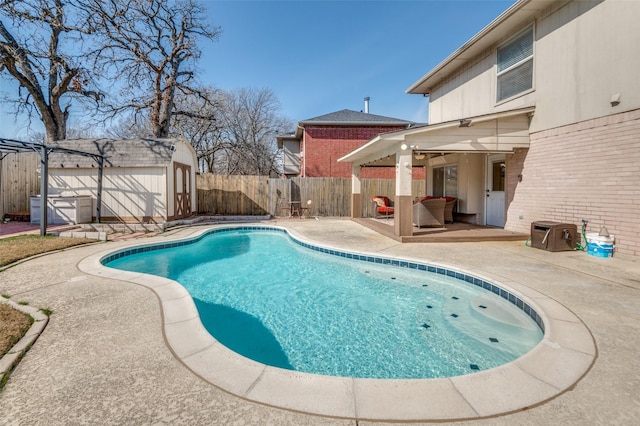 view of pool featuring a storage unit and a patio area