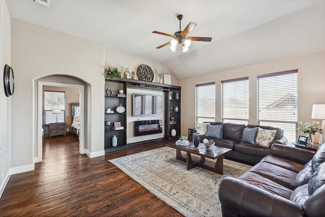 living room with lofted ceiling, dark hardwood / wood-style floors, and ceiling fan