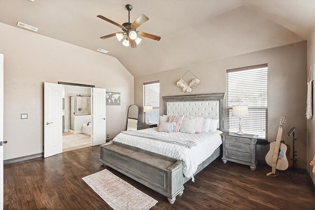 bedroom featuring lofted ceiling, ensuite bath, dark wood-type flooring, and ceiling fan