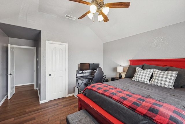 bedroom featuring dark hardwood / wood-style flooring, vaulted ceiling, and ceiling fan