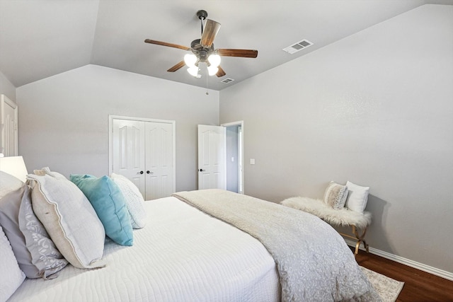 bedroom with ceiling fan, lofted ceiling, dark hardwood / wood-style flooring, and a closet