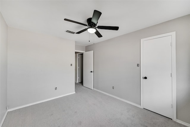 unfurnished bedroom with light colored carpet and ceiling fan