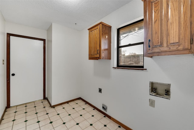 laundry room with cabinets, electric dryer hookup, hookup for a washing machine, and a textured ceiling