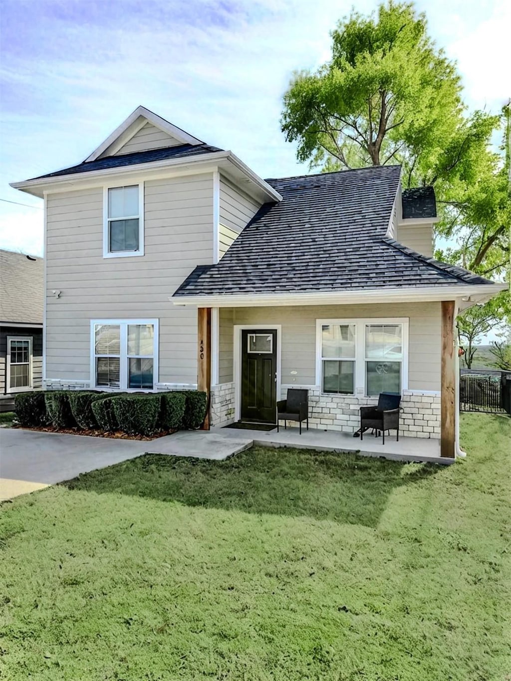 rear view of property with a yard and a patio