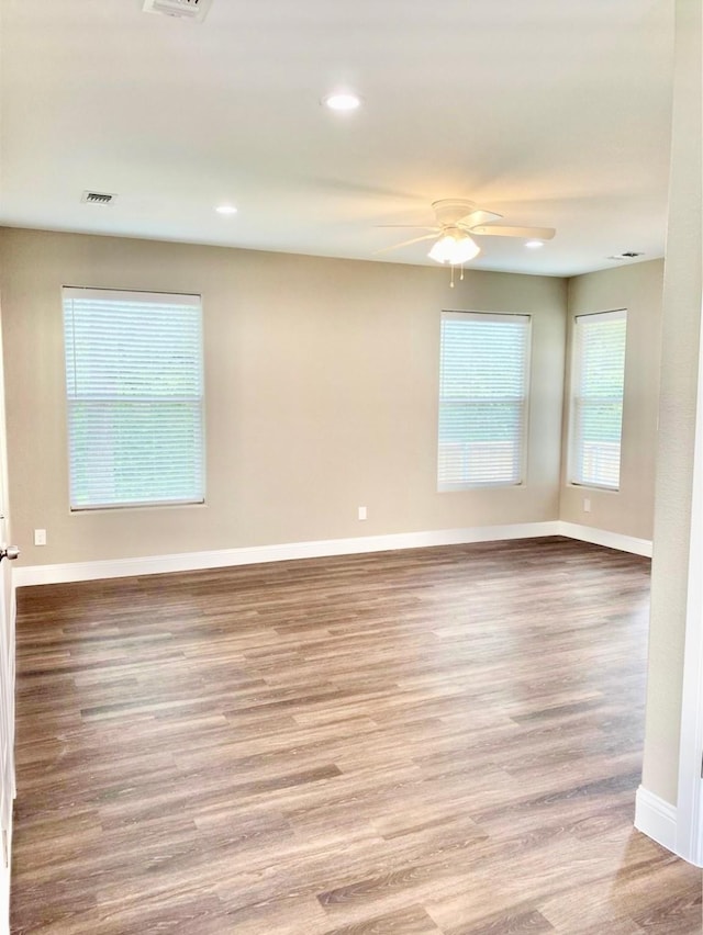 empty room featuring ceiling fan, recessed lighting, visible vents, baseboards, and light wood-type flooring