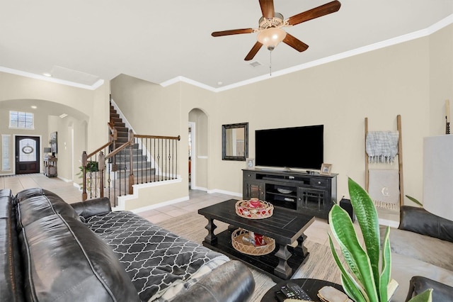 tiled living room featuring crown molding and ceiling fan