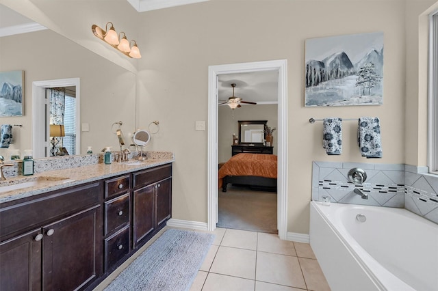 bathroom featuring crown molding, vanity, a bathing tub, ceiling fan, and tile patterned flooring