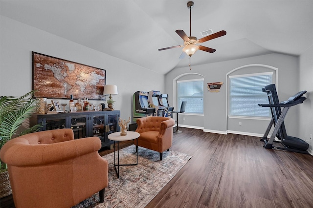 living area with ceiling fan, lofted ceiling, and dark hardwood / wood-style floors