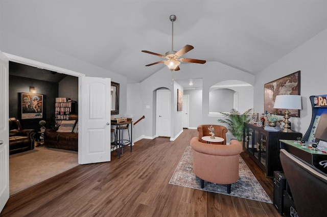 interior space featuring ceiling fan, lofted ceiling, and dark hardwood / wood-style floors