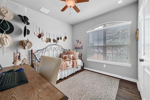 bedroom with dark hardwood / wood-style floors and ceiling fan