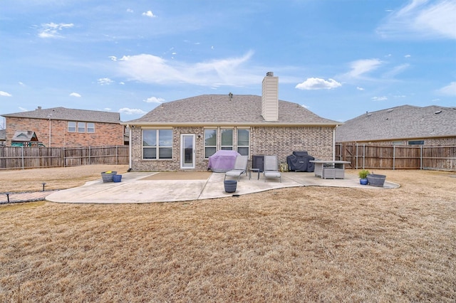 back of property featuring a yard and a patio