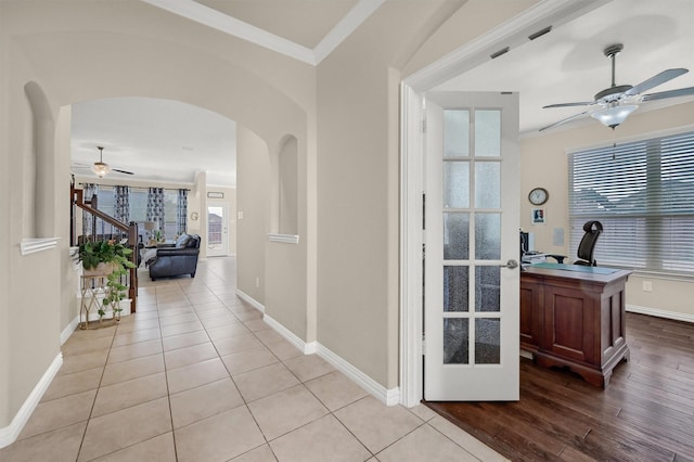 hallway featuring crown molding and light hardwood / wood-style floors