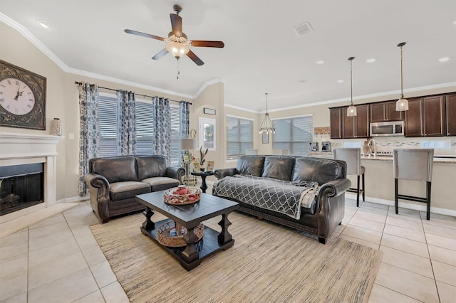 living room featuring light tile patterned floors, crown molding, and ceiling fan