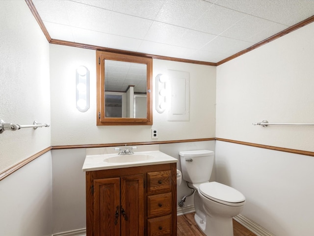 bathroom featuring ornamental molding, toilet, wood-type flooring, and vanity