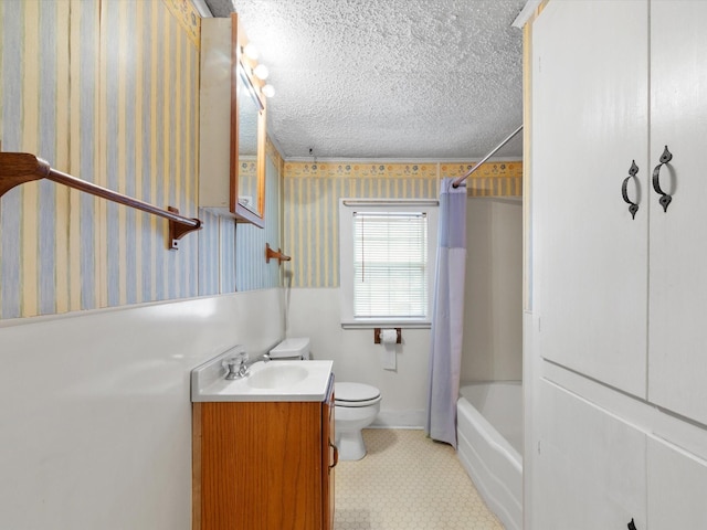 full bathroom with vanity, shower / tub combo, toilet, and a textured ceiling