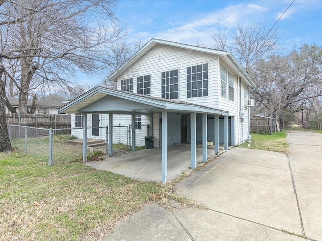 view of front of house with a carport and a front lawn