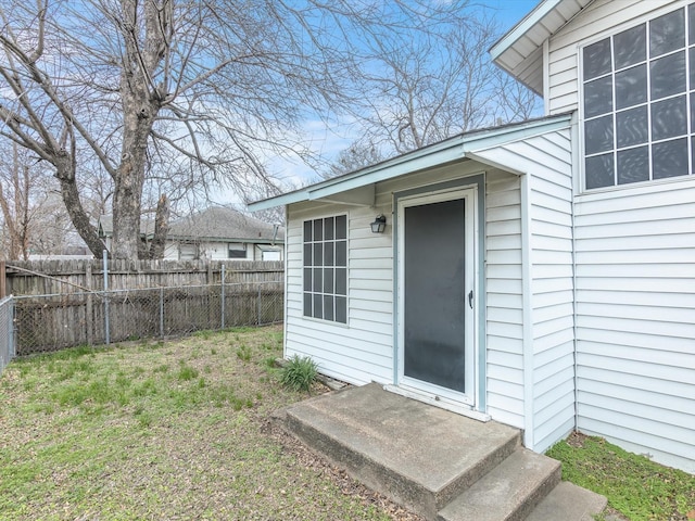 property entrance featuring a lawn