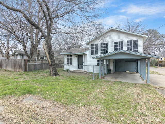 tri-level home featuring a carport and a front yard