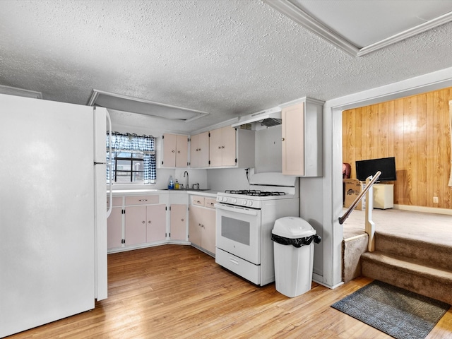 kitchen with white appliances, sink, light hardwood / wood-style floors, and white cabinets