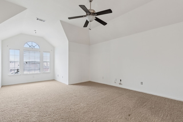 spare room featuring lofted ceiling, carpet, and ceiling fan