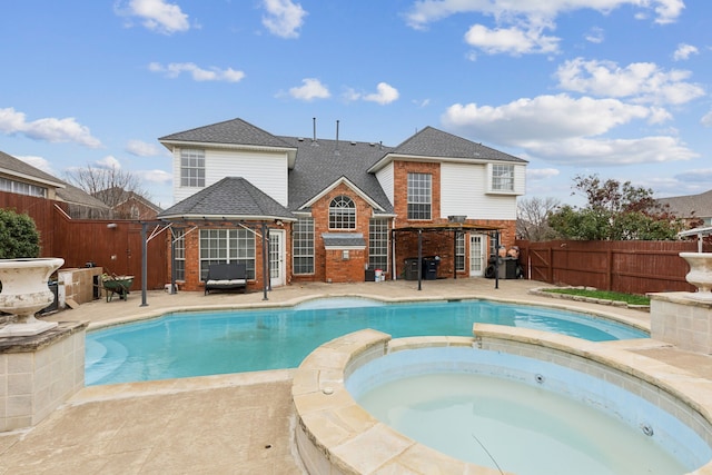 view of swimming pool featuring an in ground hot tub and a patio