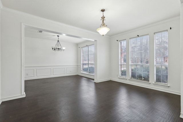 unfurnished dining area featuring ornamental molding, a healthy amount of sunlight, dark hardwood / wood-style flooring, and a chandelier