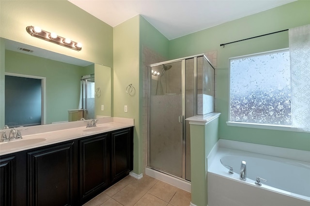 bathroom with tile patterned floors, shower with separate bathtub, and vanity