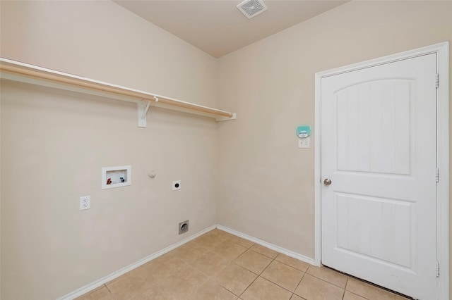 laundry room featuring gas dryer hookup, washer hookup, light tile patterned flooring, and electric dryer hookup