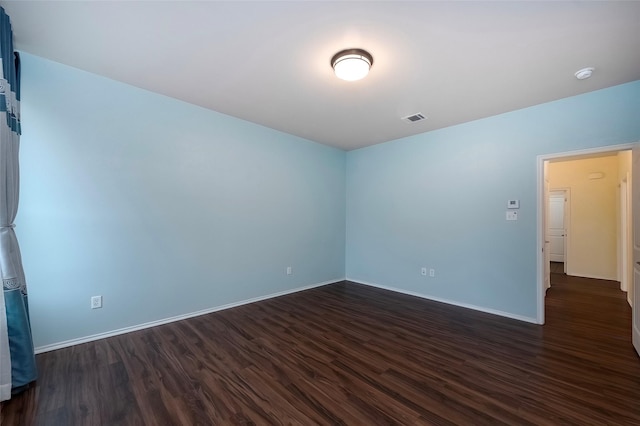 empty room featuring dark wood-type flooring