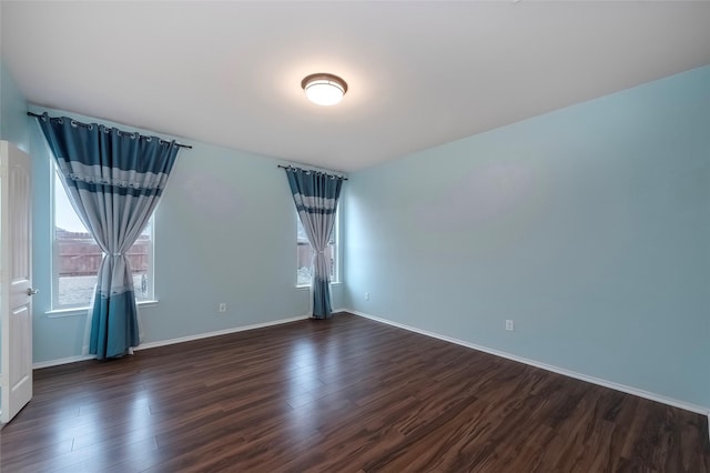 spare room featuring dark hardwood / wood-style flooring