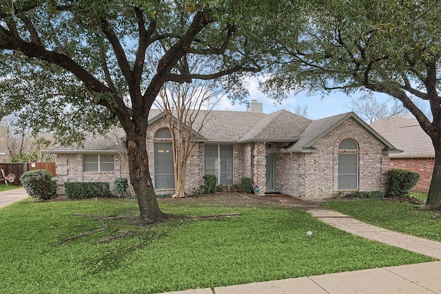 ranch-style home with a front lawn