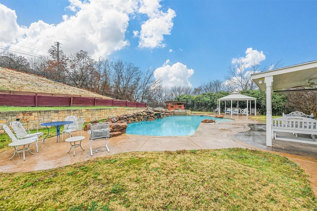 view of swimming pool featuring a lawn, a fenced in pool, a patio, fence, and a gazebo