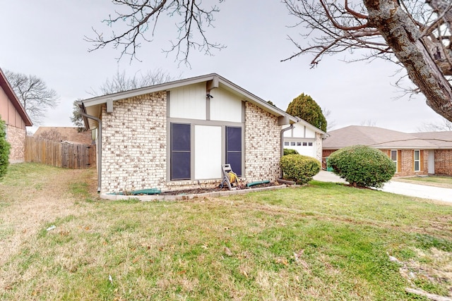 view of front of property with a garage and a front lawn