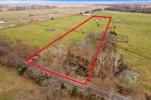 birds eye view of property with a rural view