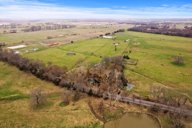 birds eye view of property featuring a water view and a rural view