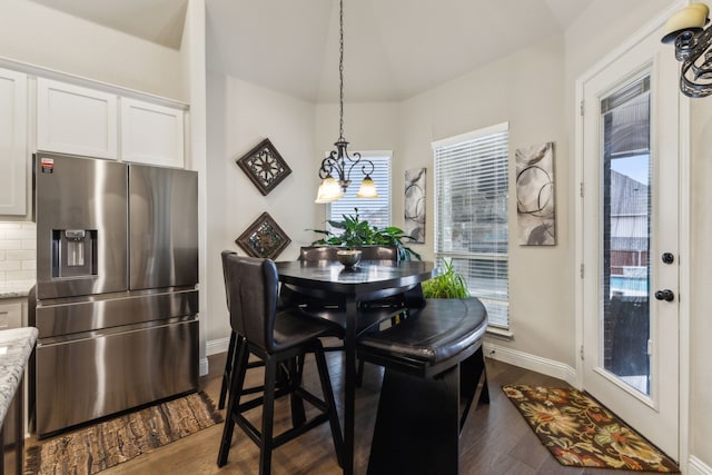dining space featuring baseboards and dark wood-type flooring