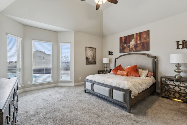 carpeted bedroom with vaulted ceiling, baseboards, and ceiling fan