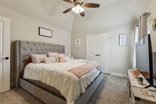 carpeted bedroom with a closet, a ceiling fan, baseboards, and vaulted ceiling