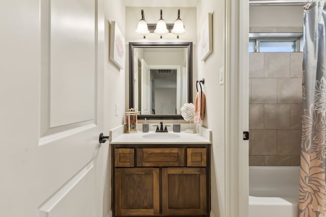 bathroom featuring shower / bath combo with shower curtain and vanity