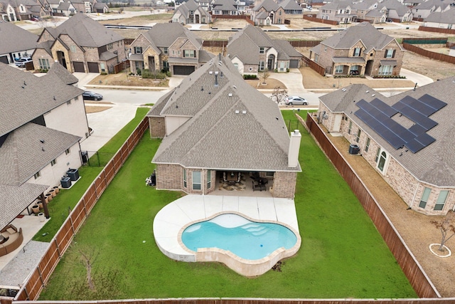 exterior space featuring a residential view, a fenced backyard, and a patio area