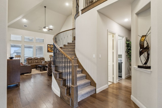 stairway featuring wood-type flooring, ceiling fan, and high vaulted ceiling