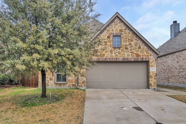 view of front of property featuring a garage and a front yard