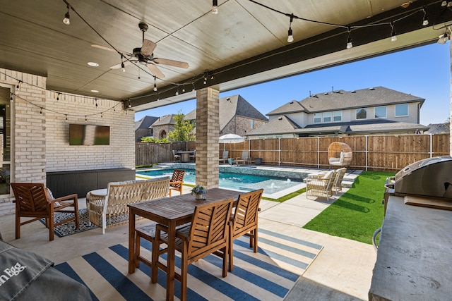 view of patio / terrace with a fenced in pool, ceiling fan, outdoor lounge area, area for grilling, and pool water feature