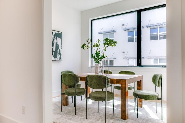 carpeted dining space featuring a healthy amount of sunlight