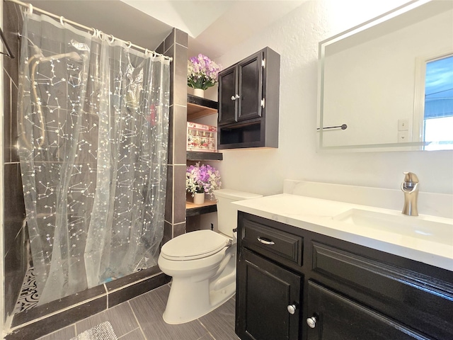 bathroom featuring vanity, toilet, curtained shower, and tile patterned flooring